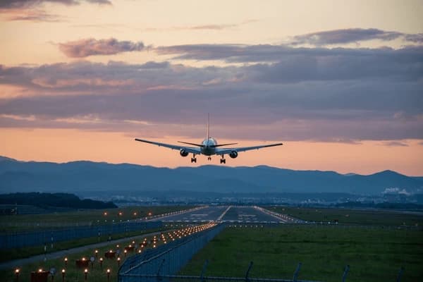 Airplane landing at dusk — entering new markets